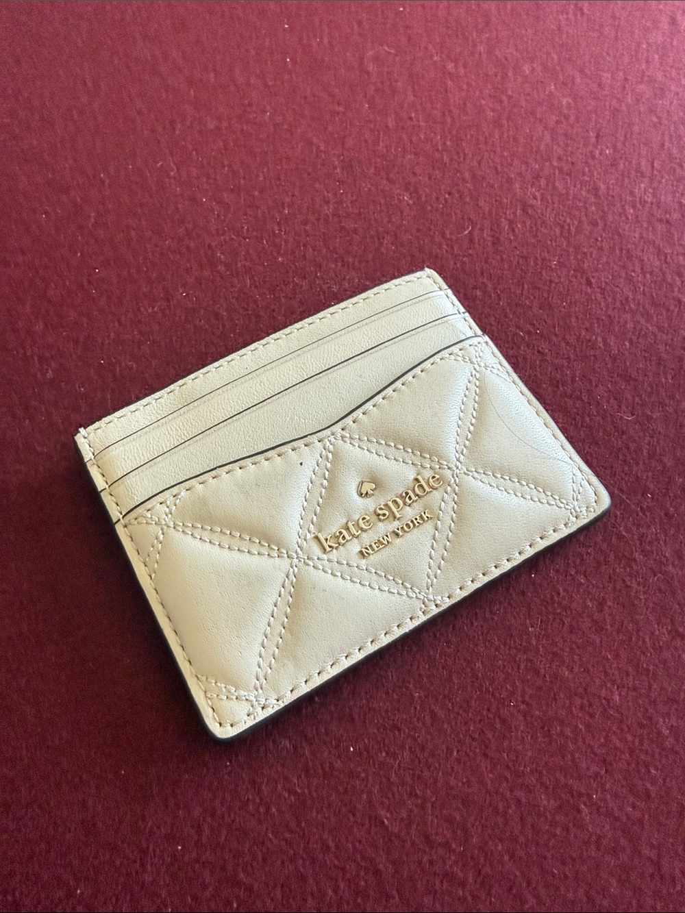 kate spade cream quilted leather card case with gold logo